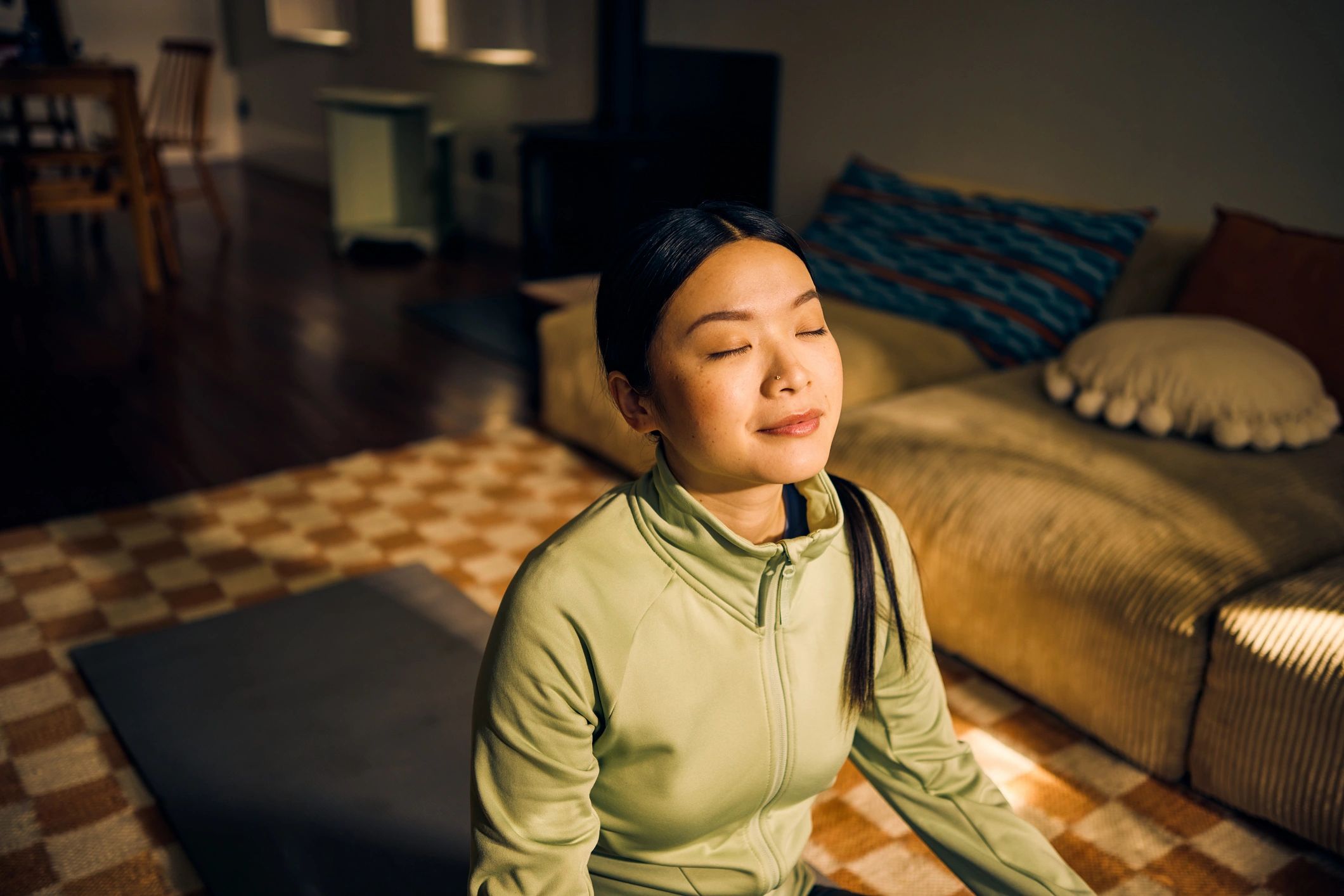 Person meditating in a calm indoor space.