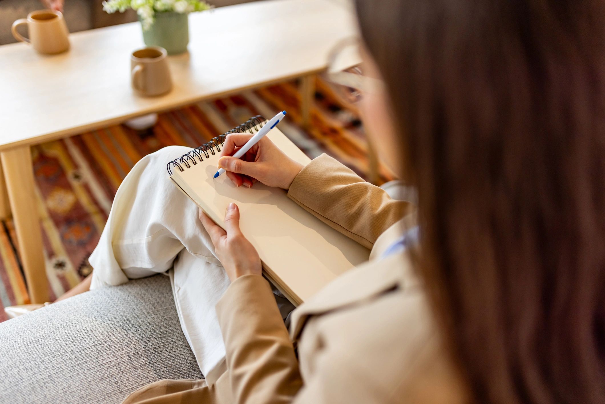 Person journaling in a calm, cozy setting